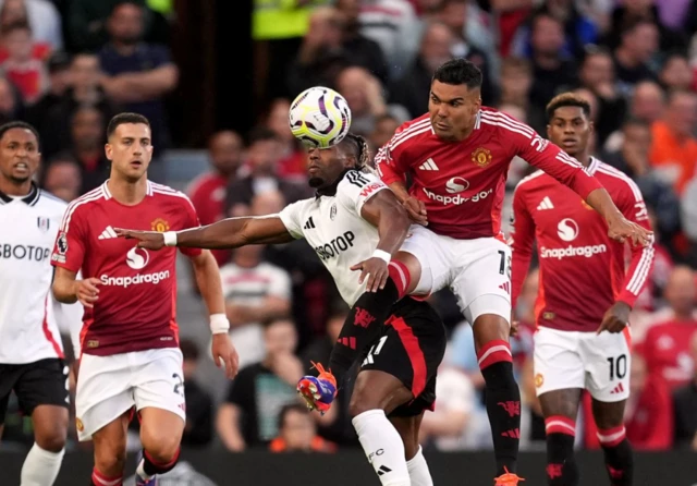 Adama Traore and Manchester United's Casemiro (right) battle for the ball