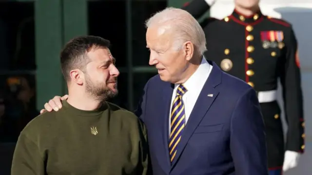 Joe Biden with his arm around President Zelensky