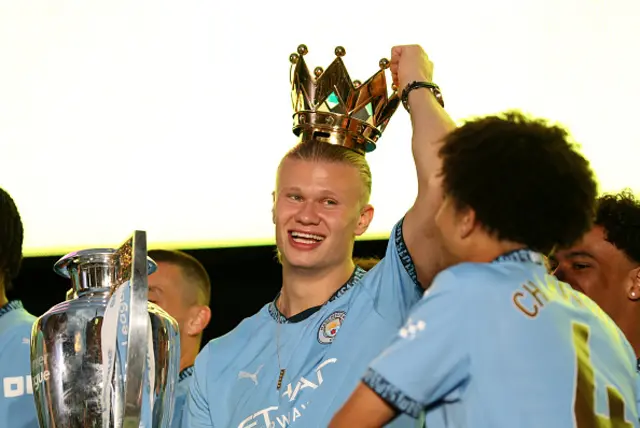 Erling Haaland of Manchester City celebrates with the crown of the Premier League trophy