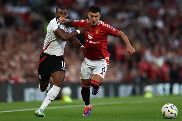 Adama Traore (L) vies with Manchester United's Argentinian defender #06 Lisandro Martinez