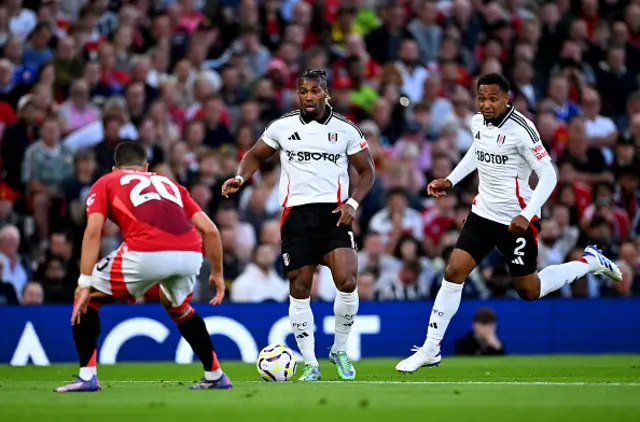 Adama Traore of Fulham controls the ball whilst under pressure from Diogo Dalot