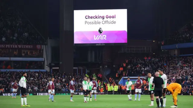 VAR checks and disallows a goal by Ollie Watkins of Aston Villa during the Premier League match between Aston Villa and Liverpool FC at Villa Park on May 13, 2024 in Birmingham, England.