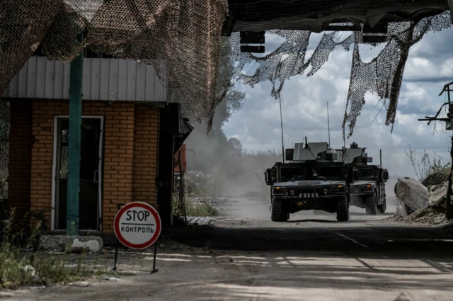 Ukrainian military vehicles at a Russian border crossing