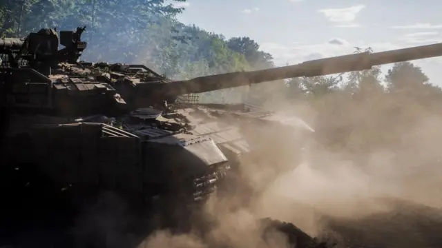 Ukrainian servicemen repair a tank that was evacuated from Russian territory to Sumy region, not far from the Ukraine - Russian border