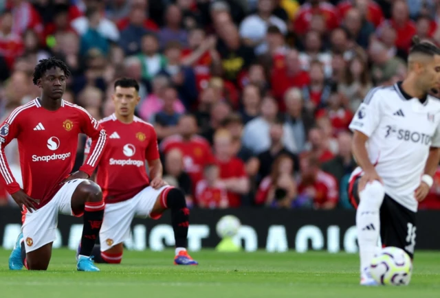 Manchester United's Kobbie Mainoo takes the knee before the match