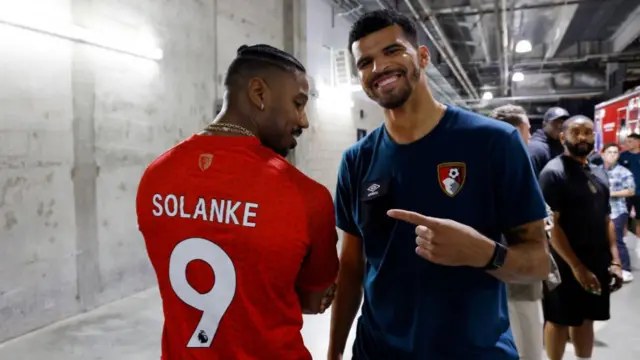 Dominic Solanke points to Michael B Jordan wearing a Bournemouth shirt bearing his name