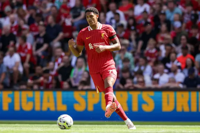 Liverpool defender Jarell Quansah passing the ball with his left foot