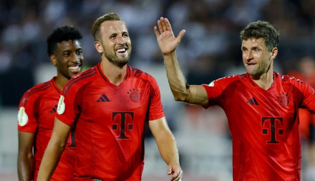 Bayern Munich's Thomas Muller, Kingsley Coman and Harry Kane celebrate after the match