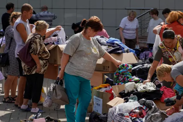 Group of people collecting clothes at humanitarian aid collection points in downtown Kursk