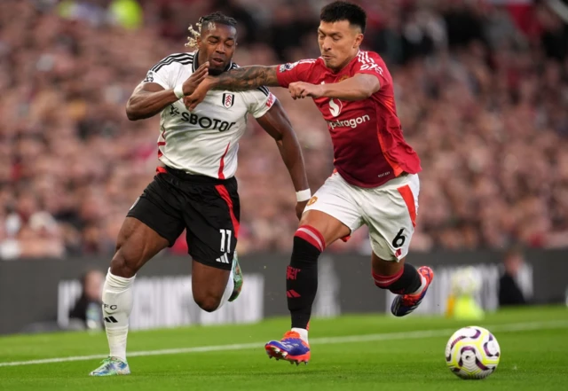 Fulham's Adama Traore attempts to get past Manchester United's Lisandro Martinez