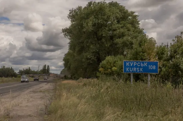 Wide shot of road and bushland with Kursk road sign with the number 108