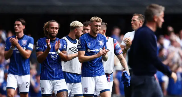 Ipswich players clap the fans at full time