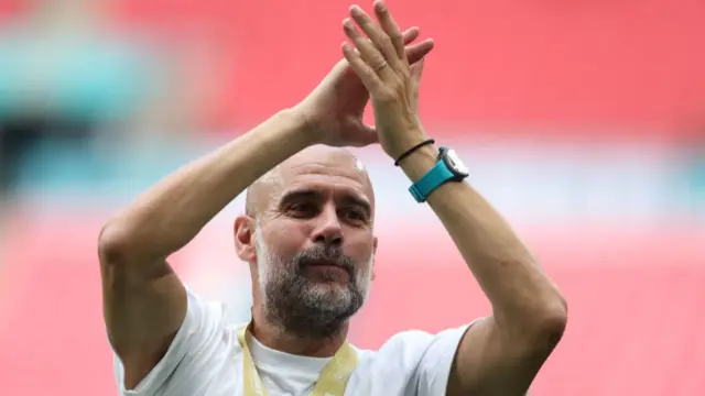 Pep Guardiola applauds the Manchester City fans following the Community Shield