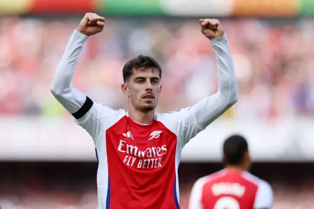 Havertz holds his fists into the air to celebrate his goal