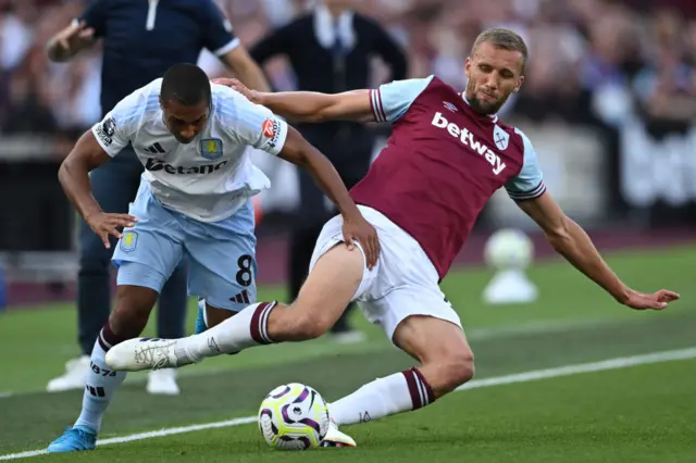 Soucek slides into a challenge on Tielemans