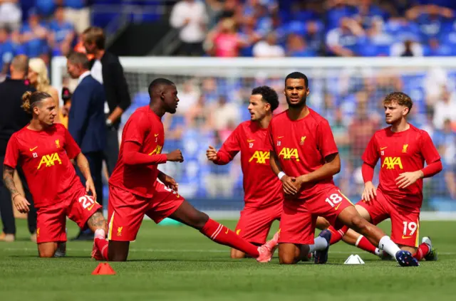 Liverpool players warm up ahead of kick off