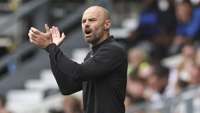 Paul Warne claps his hands on the touchline