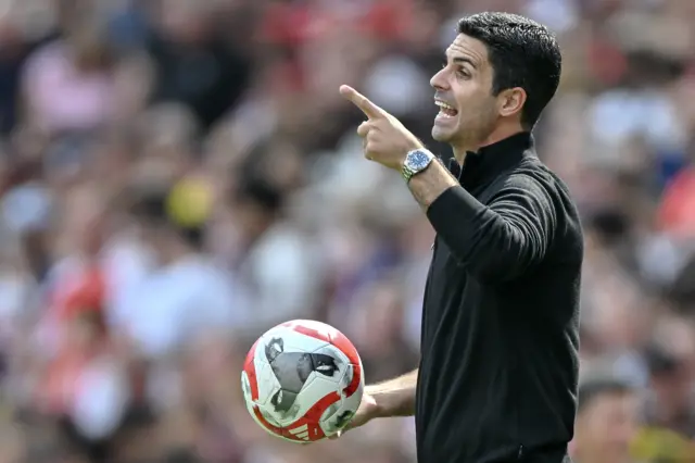 Mikel Arteta points orders while holding a match ball