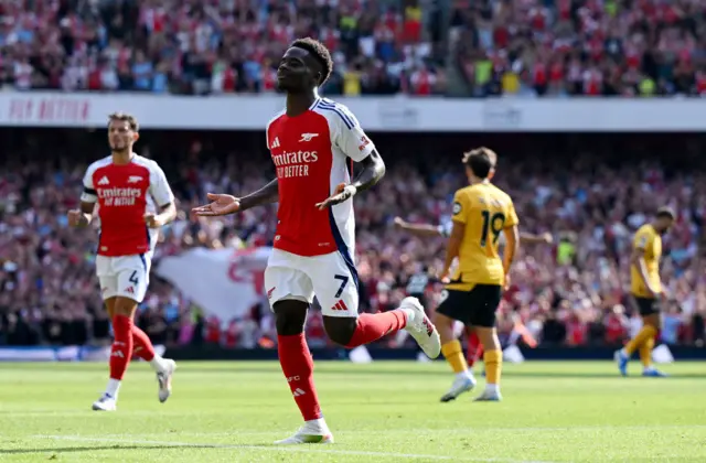 Saka runs to the corner to celebrate his goal