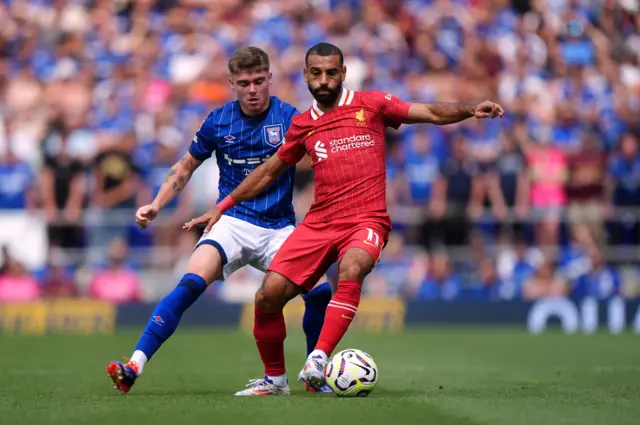 Salah holds off a defender while holding up play