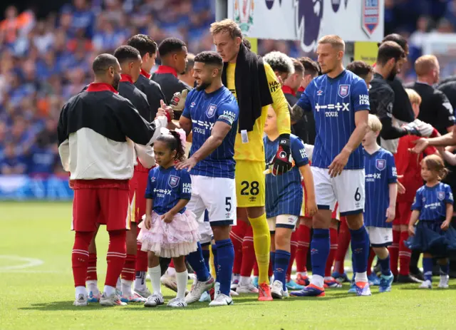 Players walk to do the handshake before kick off