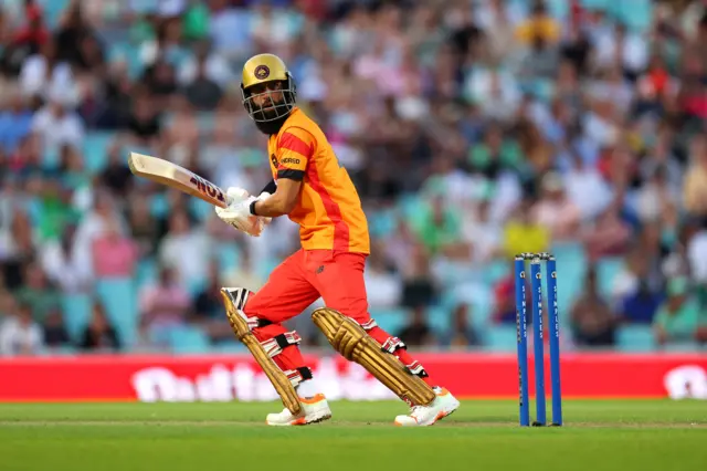 Moeen Ali runs after hitting the ball