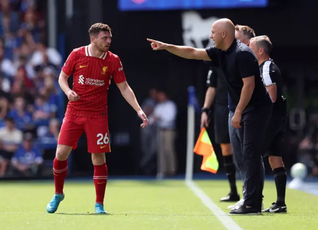 Andy Robertson receives instructions from Slot