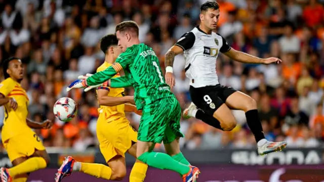 Barcelona's Marc-Andre ter Stegen in action with Valencia's Hugo Duro