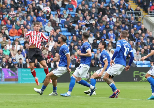 Dennis Cirkin heads a ball for Sunderland against Cardiff, setting up a goal