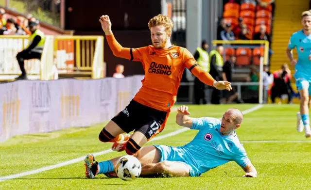 Dundee United's Luca Stephenson is tackled by St Mirren's Alex Gogic