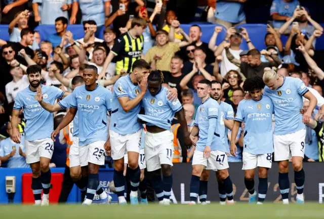 City players walk back to kick off after celebrating their second goal