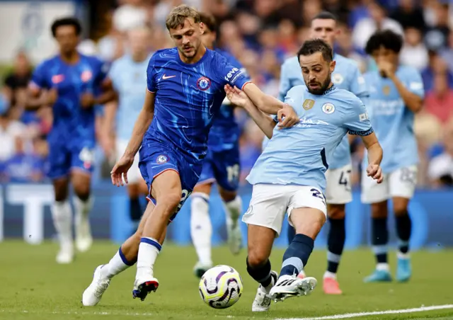 Bernardo Silva passes the ball under pressure