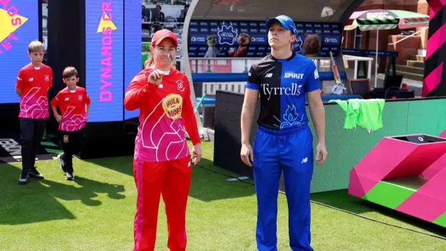 Tammy Beaumont (L) of Welsh Fire flips the coin as Heather Knight (R) of London Spirit looks on prior to The Hundred Final match between Welsh Fire Women and London Spirit Women