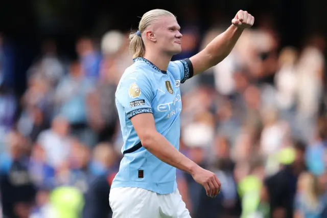 Haaland fist pumps to the fans after scoring his goal