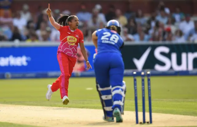 Ismail celebrates with her finger above her head on Gibson's dismissal