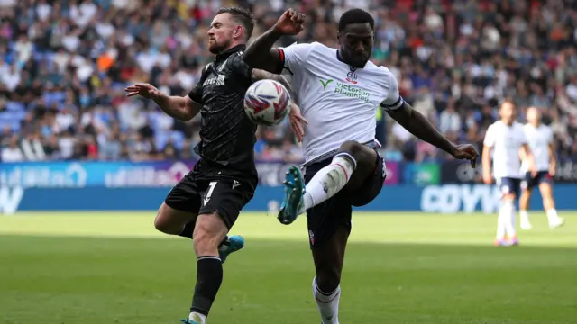 Jack Marriott of Wrexham battles with Ricardo Santos of Bolton Wanderers