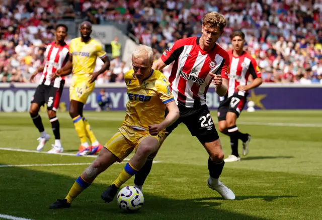 Hughes tries to wriggle away from a marker in the corner