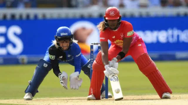 Hayley Matthews of Welsh Fire bats watched by Georgia Redmayne of London Spirit during The Hundred Final between London Spirit Women and Welsh Fire Women