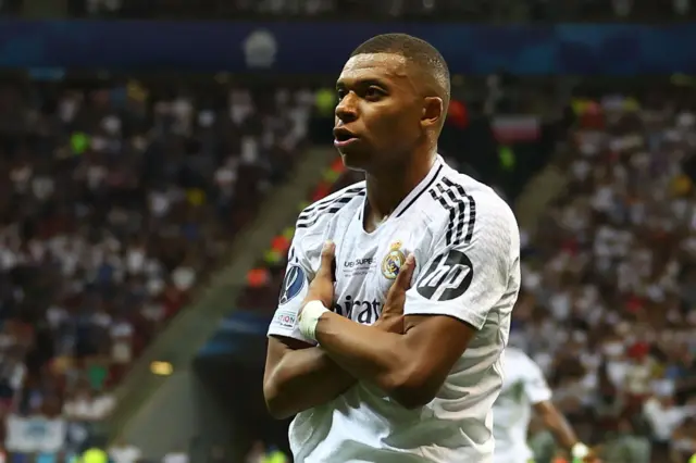 Kylian Mbappe celebrating with his arms folded after scoring in the Super Cup