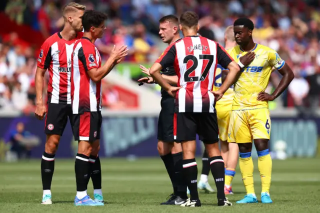 eferee Sam Barrott interacts with Christian Norgaard of Brentford during the Premier League match between Brentford FC and Crystal Palace