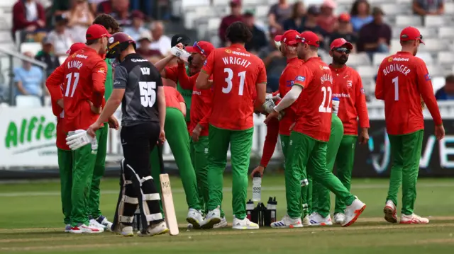 Leicestershire players congratulate Louis Kimber as James Rew departs