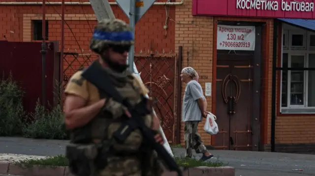 A Ukrainian soldier on patrol in the Russian town of Sudzha