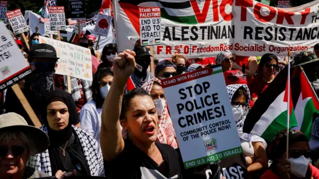 People hold signs and flags in support of Palestinians in Gaza as demonstrators rally on the sidelines of the Democratic National Convention (DNC) in Chicago, Illinois, U.S., August 19, 2024