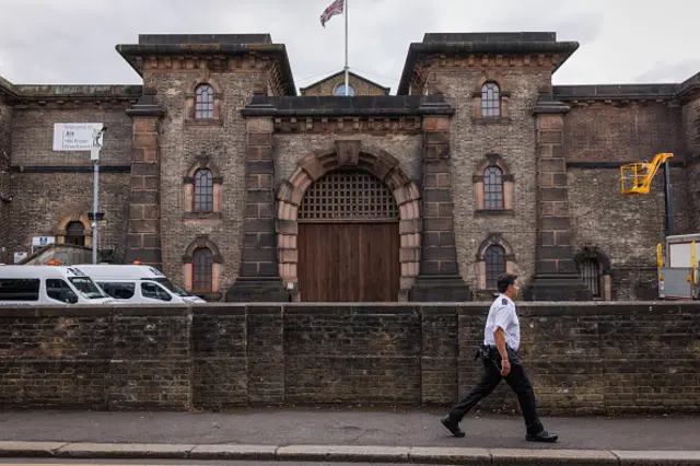 A prison guard walks past HMP Wandsworth Prison on July 12, 2024 in London