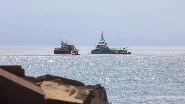 Fire Brigade and Coast Guard units search for missing people who were on board a sailboat that sank in Palermo