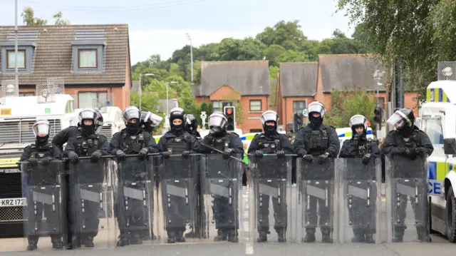 Riot police block a street in Northern Ireland following a protest outside Belfast City Hall