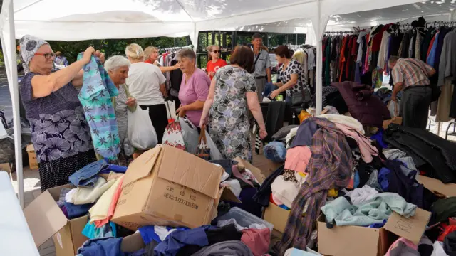 Civilians evacuated from the Kursk regional border with Ukraine receive humanitarian aid delivered by the Russian Red Cross in downtown Kursk