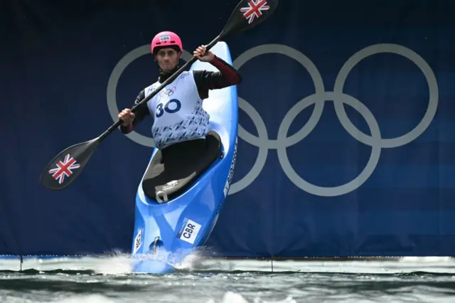 Britain's Adam Burgess takes the start as he competes in the men's kayak cross time trial canoe slalom