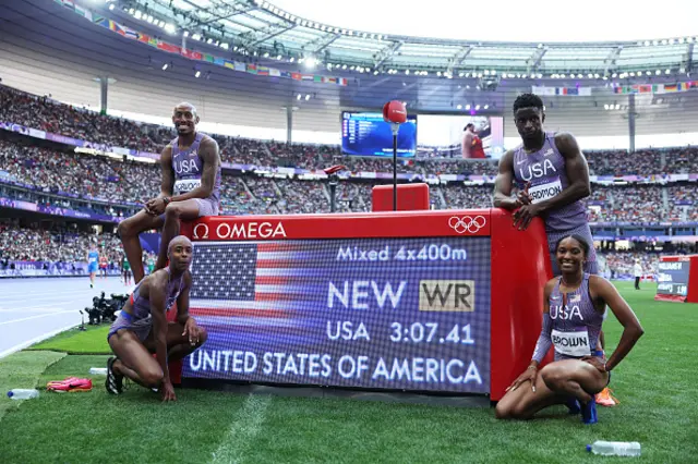 Team USA pose next to the time board