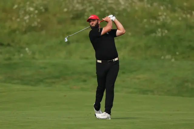 Jon Rahm plays a shot